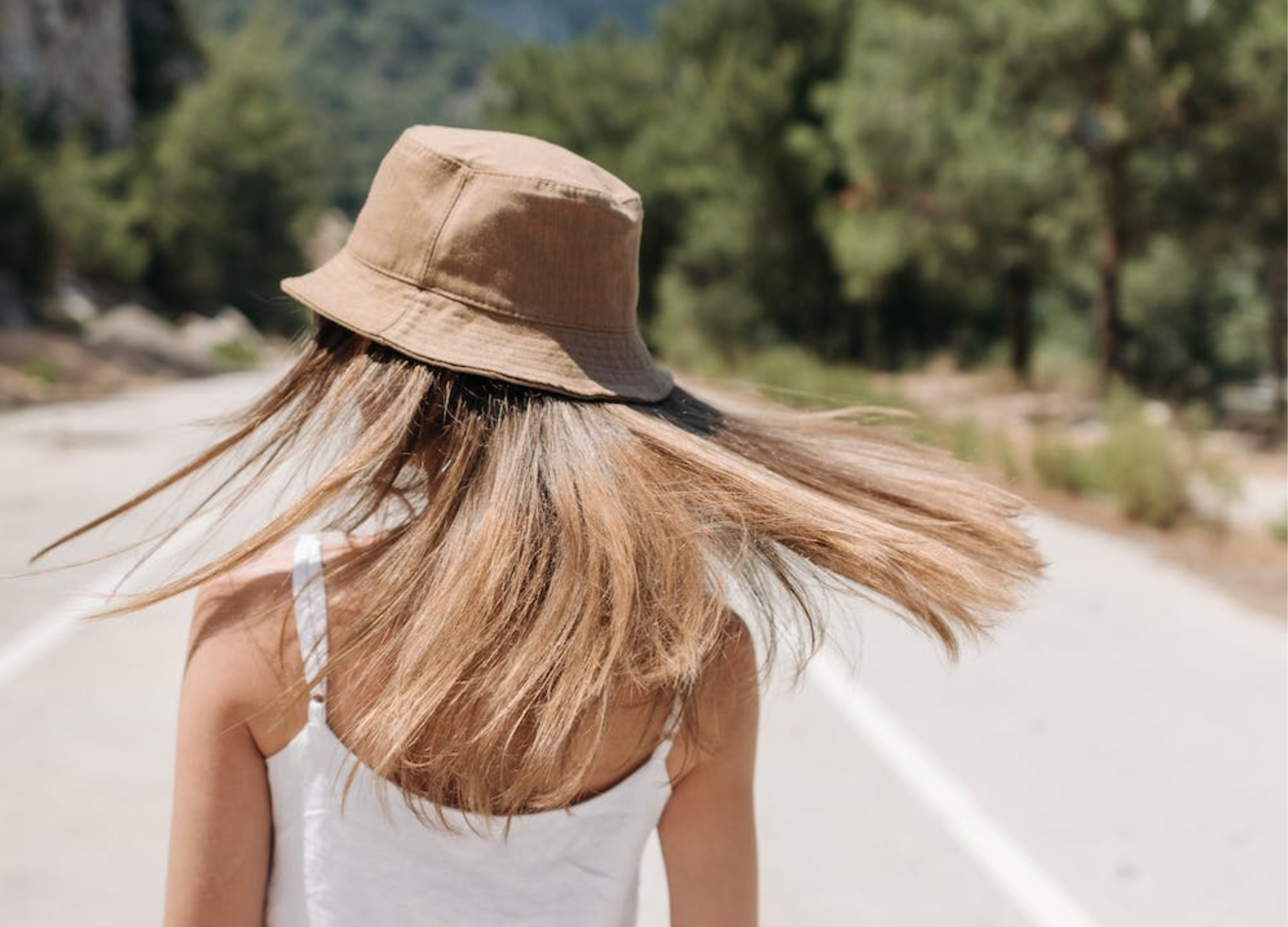 Bucket hat in sunshine with woman outside with long blonde hair